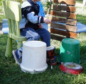 Loose parts for music - let the children play (Copy) Child playing outside musical instruments